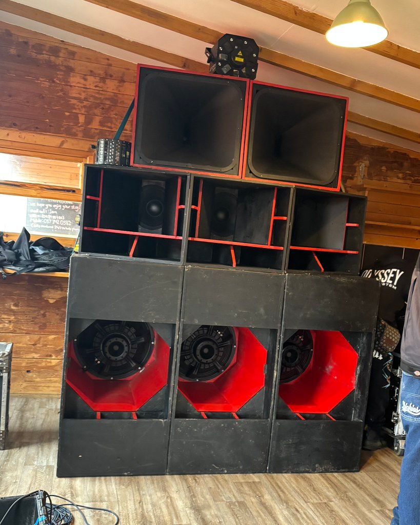 Sound system rig in wooden-walled venue