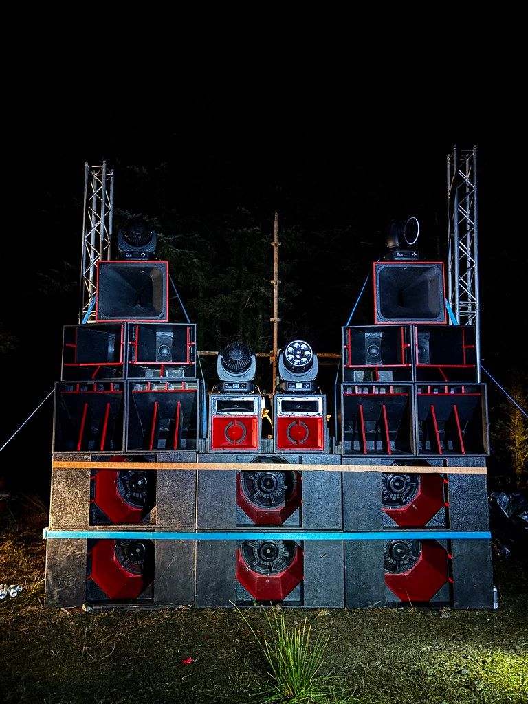 Dramatic night rig with truss towers and moving heads